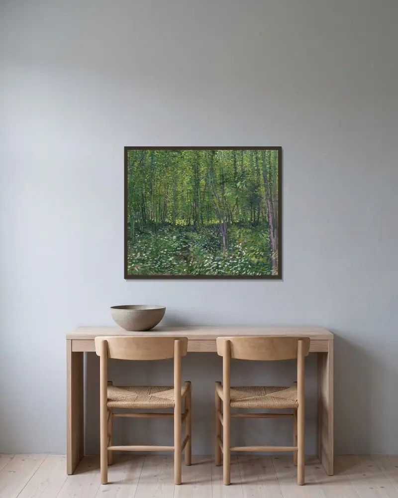 Trees and undergrowth av Vincent van Gogh inramad på en vägg