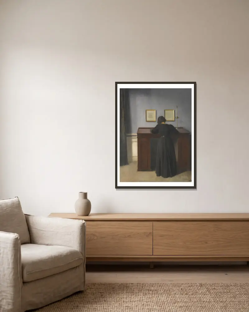 Ida am Schreibtisch stehend von Vilhelm Hammershøi gerahmt an einer Wand
