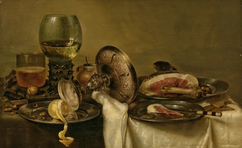 A partially draped table with an overturned tazza, roemer and glass of beer, with a partially peeled lemon and ham on pewter plates av Willem Claesz Heda
