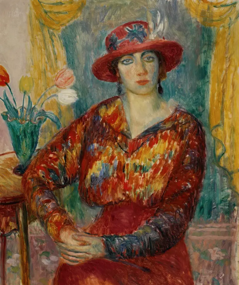Frau in roter Bluse mit Tulpen von William James Glackens